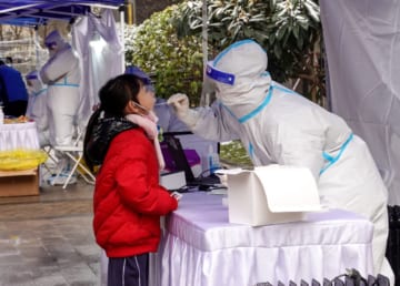中国・西安で新型コロナウイルスの検査を受ける女児（2021年12月、AFP＝時事）